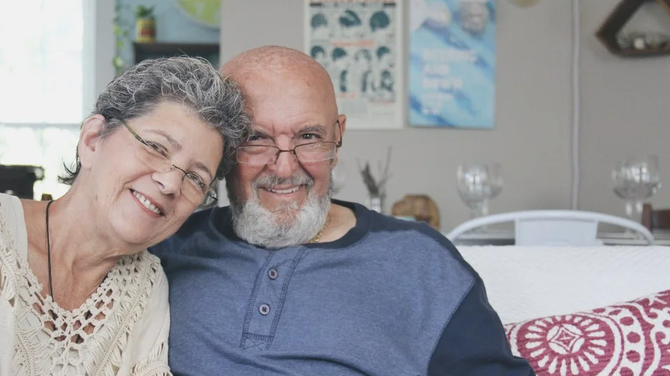 Older couple sharing a relaxed conversation at home
